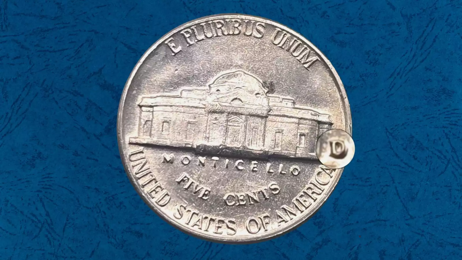 1963-D Jefferson Nickel Repunched Mint Mark showing secondary D impression visible above the primary D mint mark under magnification