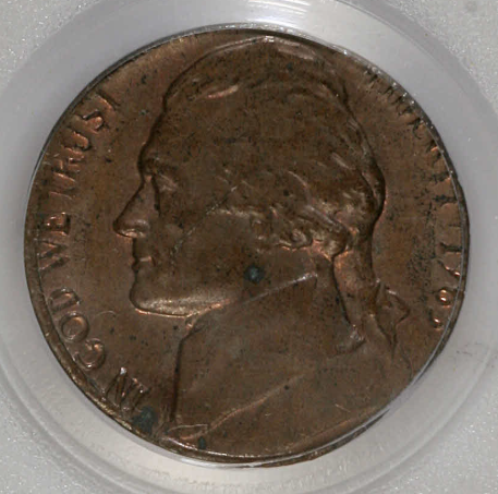 1963 Jefferson Nickel struck on a copper cent planchet showing copper-red color and smaller diameter compared to normal nickel